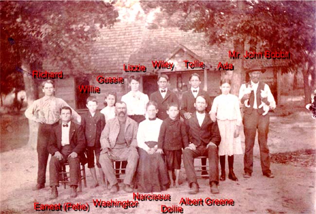 Narcissa Geanette Pernell is seated in the front row and surrounded by
her husband Washington George Faulkner and children.